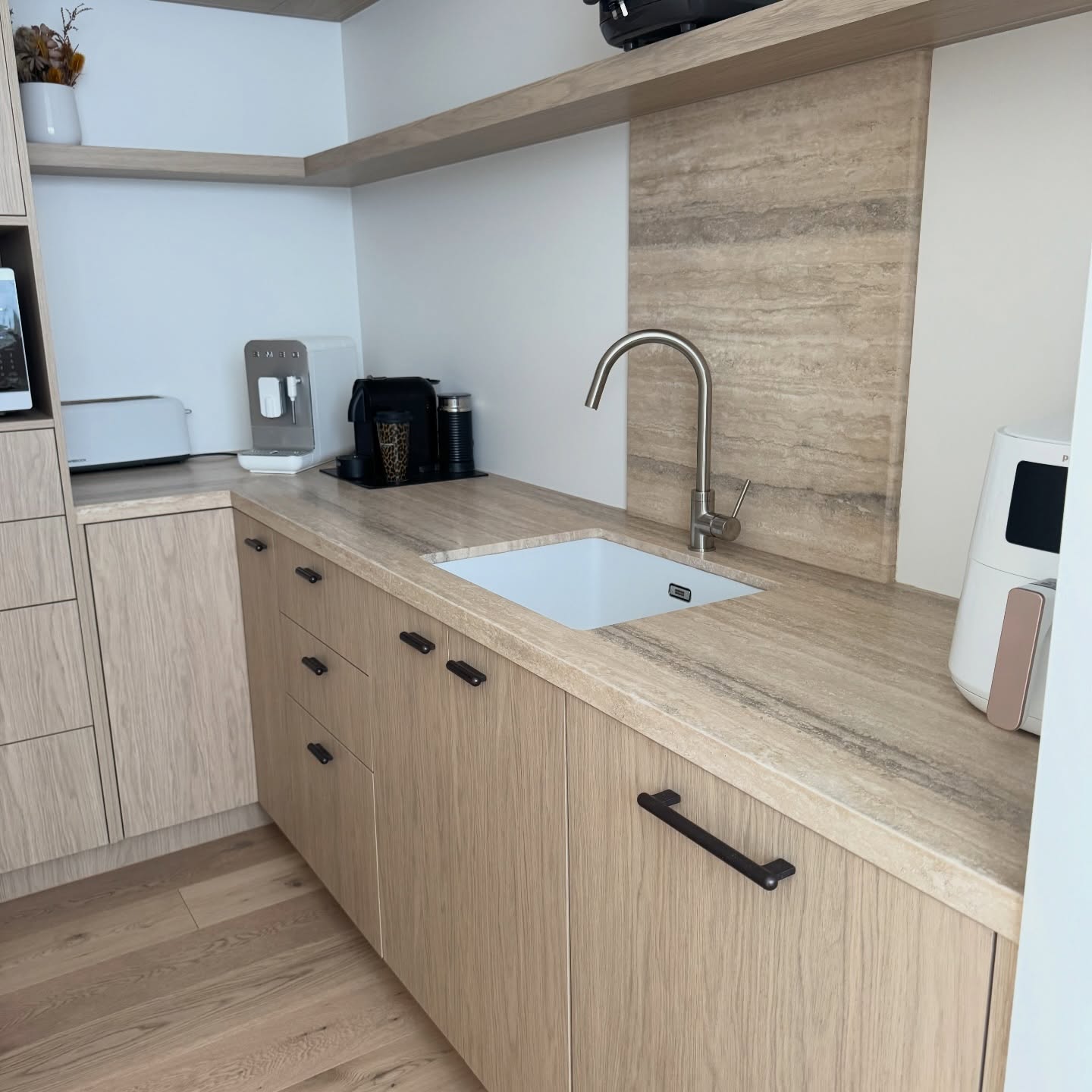 Travertine butler's pantry bench and splashback with an undermount sink, protected with Stone Shield film